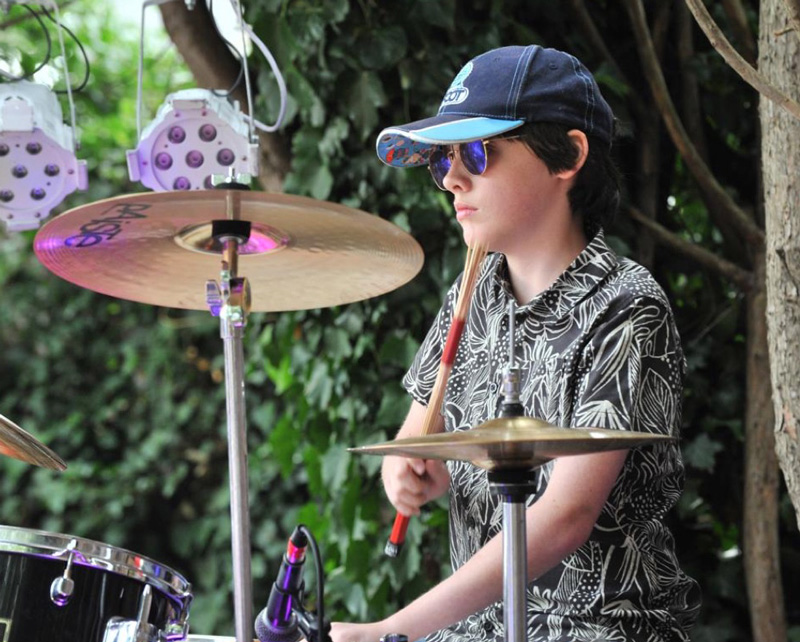 Young boy performing on drums