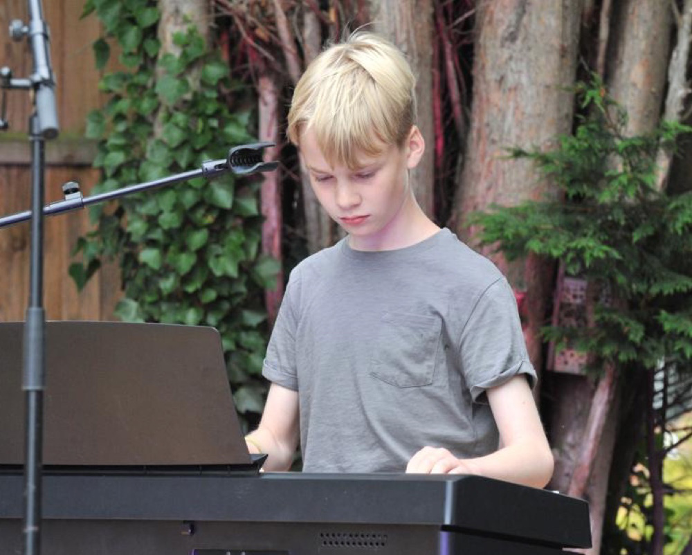 Young boy performing on keyboard